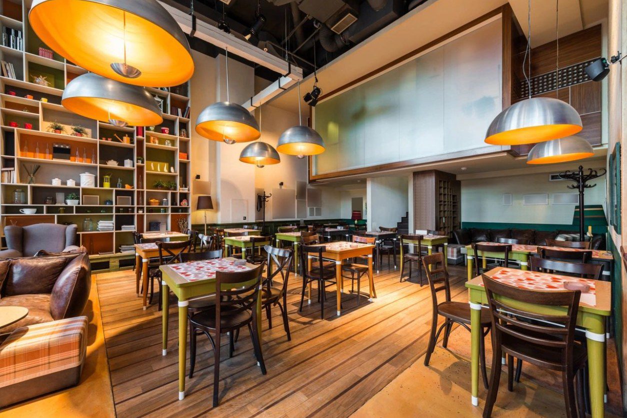 A restaurant with many tables and chairs in it