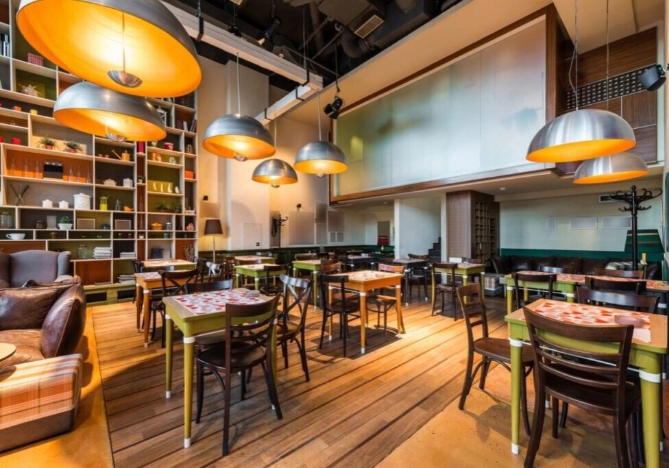 A restaurant with many tables and chairs in it